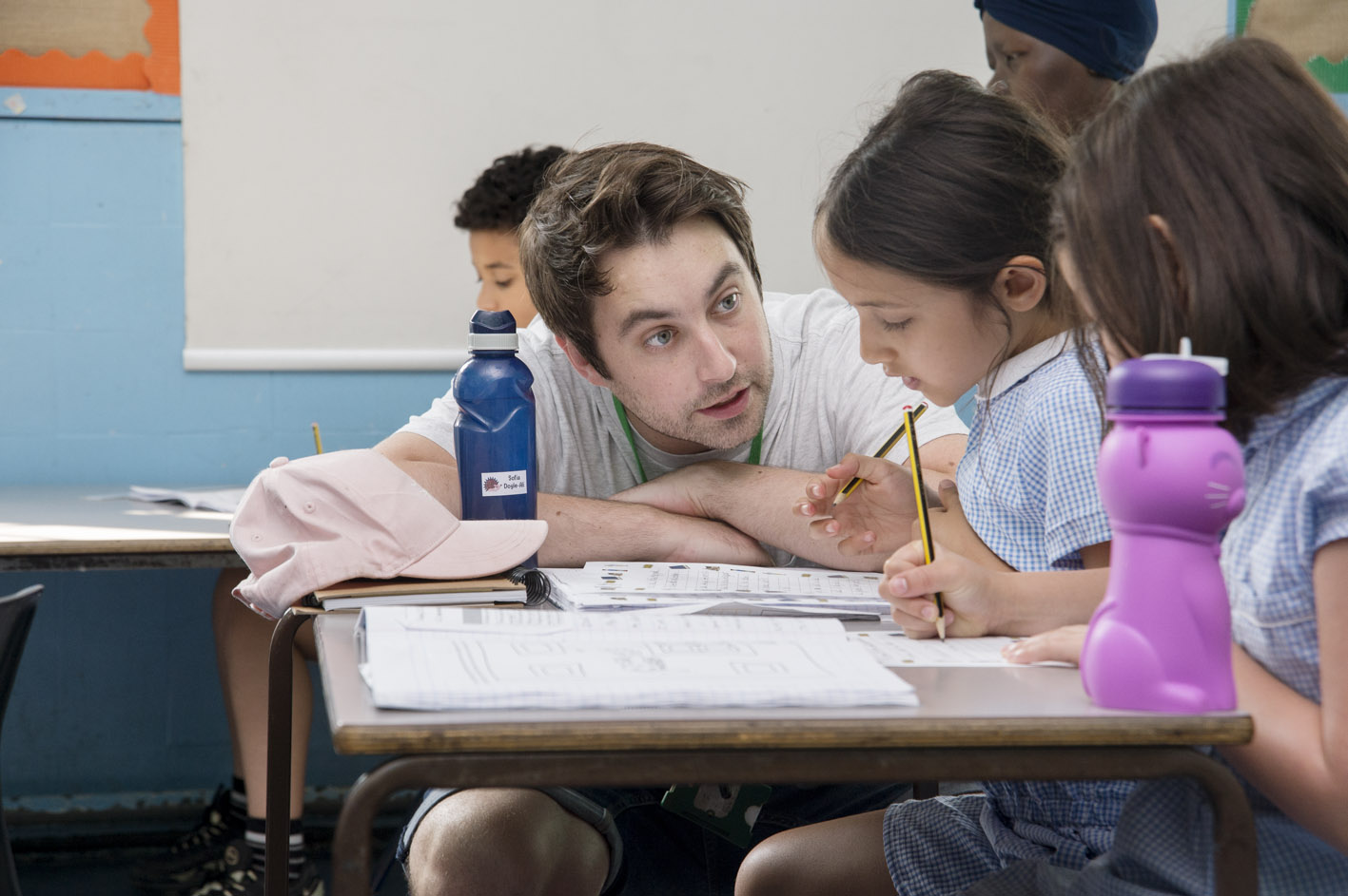 A teacher talking to pupils in a classroom 