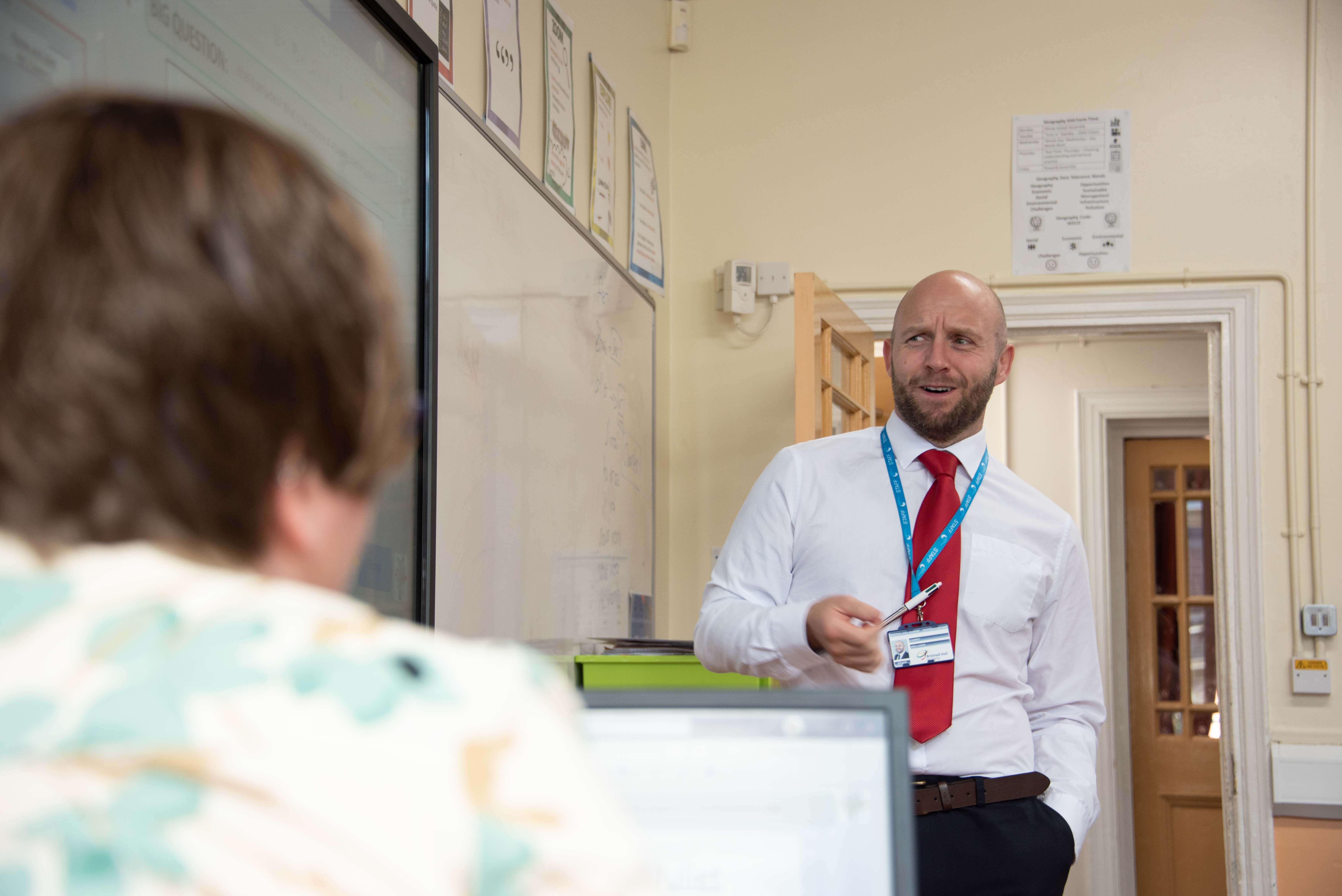 Two teachers talking in a classroom