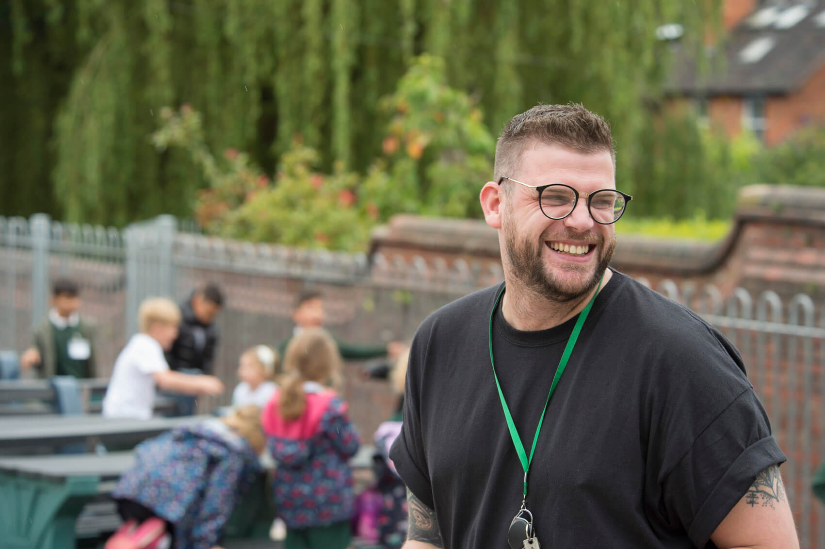 Teaching Assistant smiling in a playground