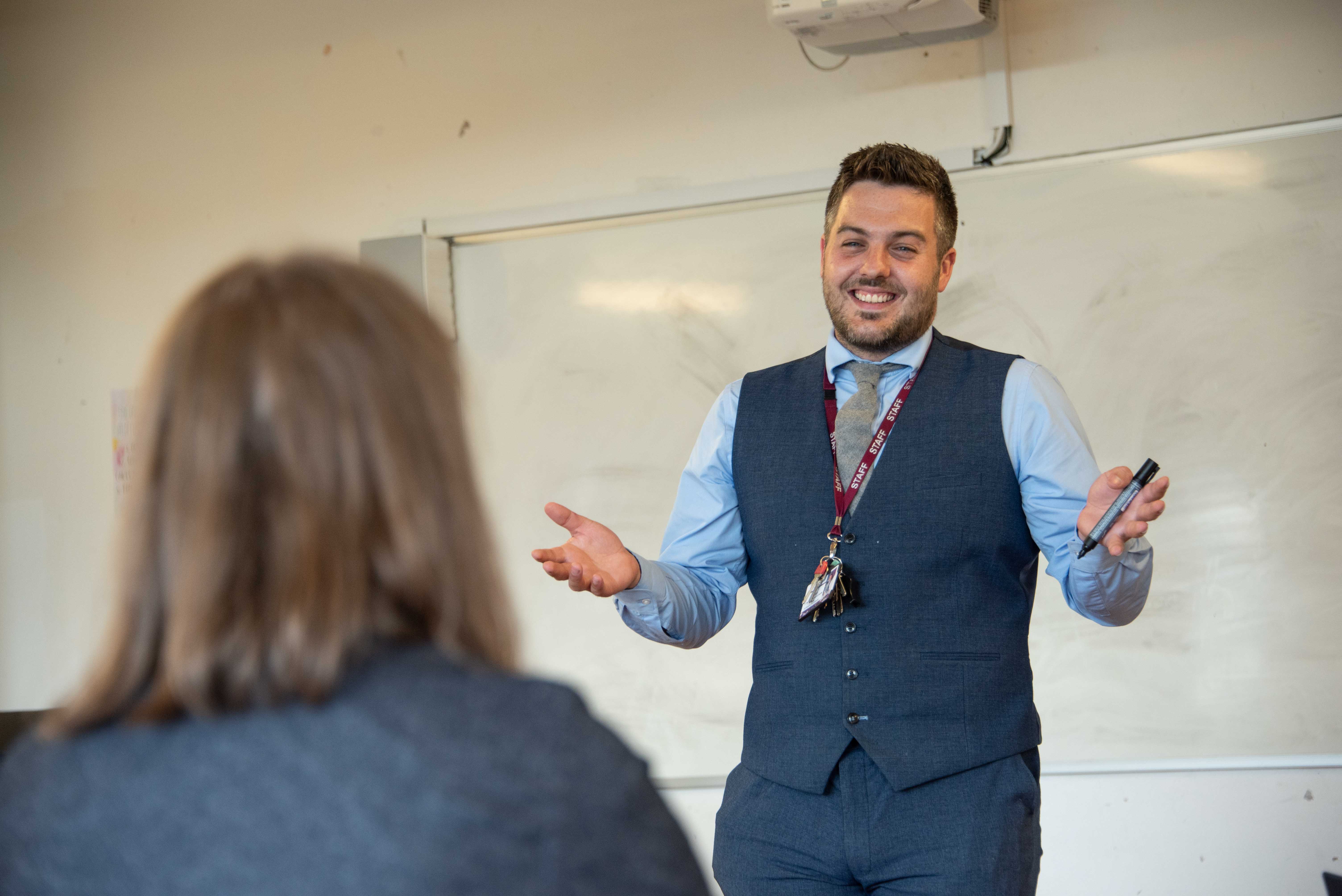 Two teachers talking in a classroom