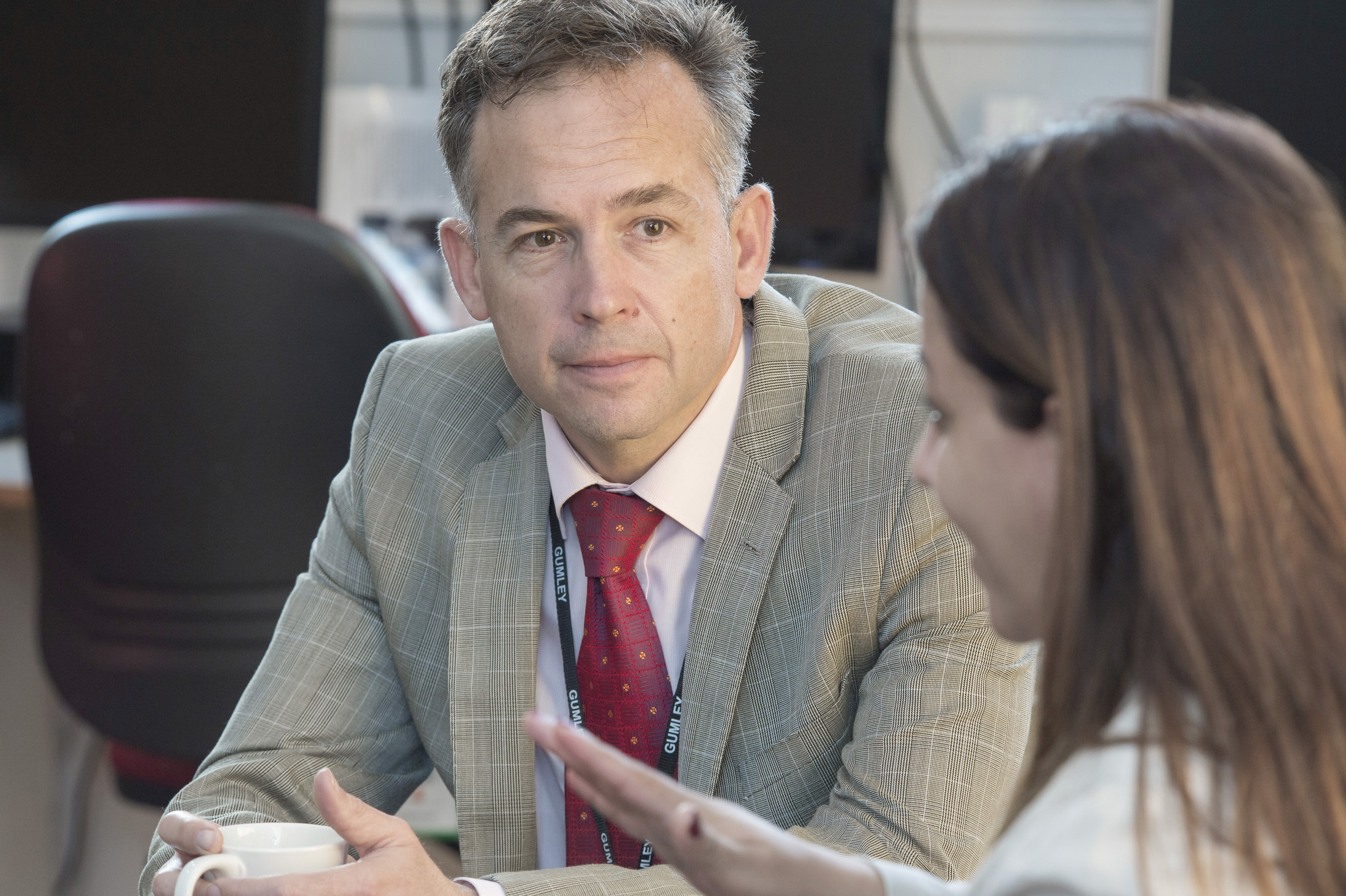 Teachers chatting in staffroom 