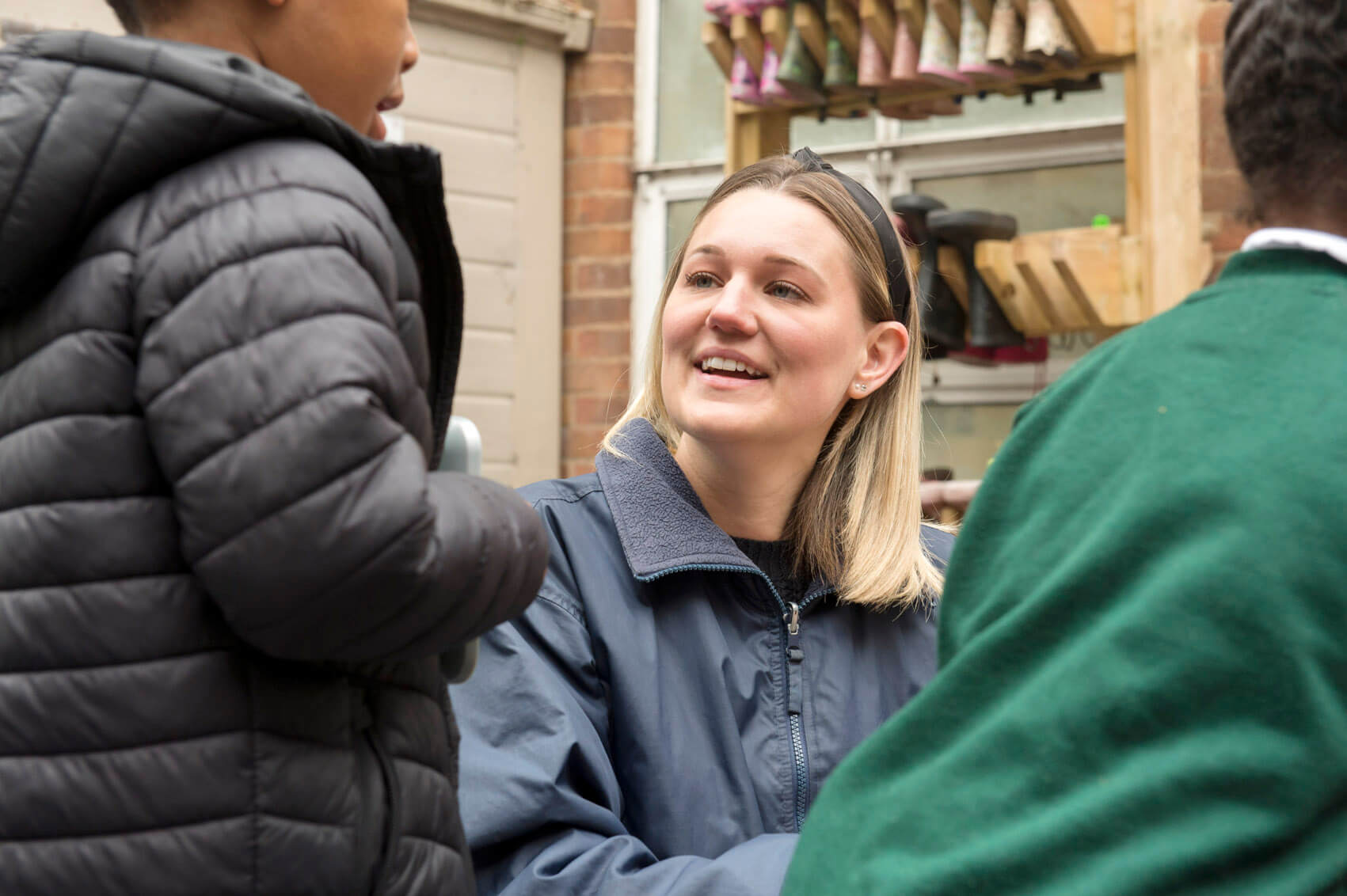 Teaching Assistant smiling with a pupil 
