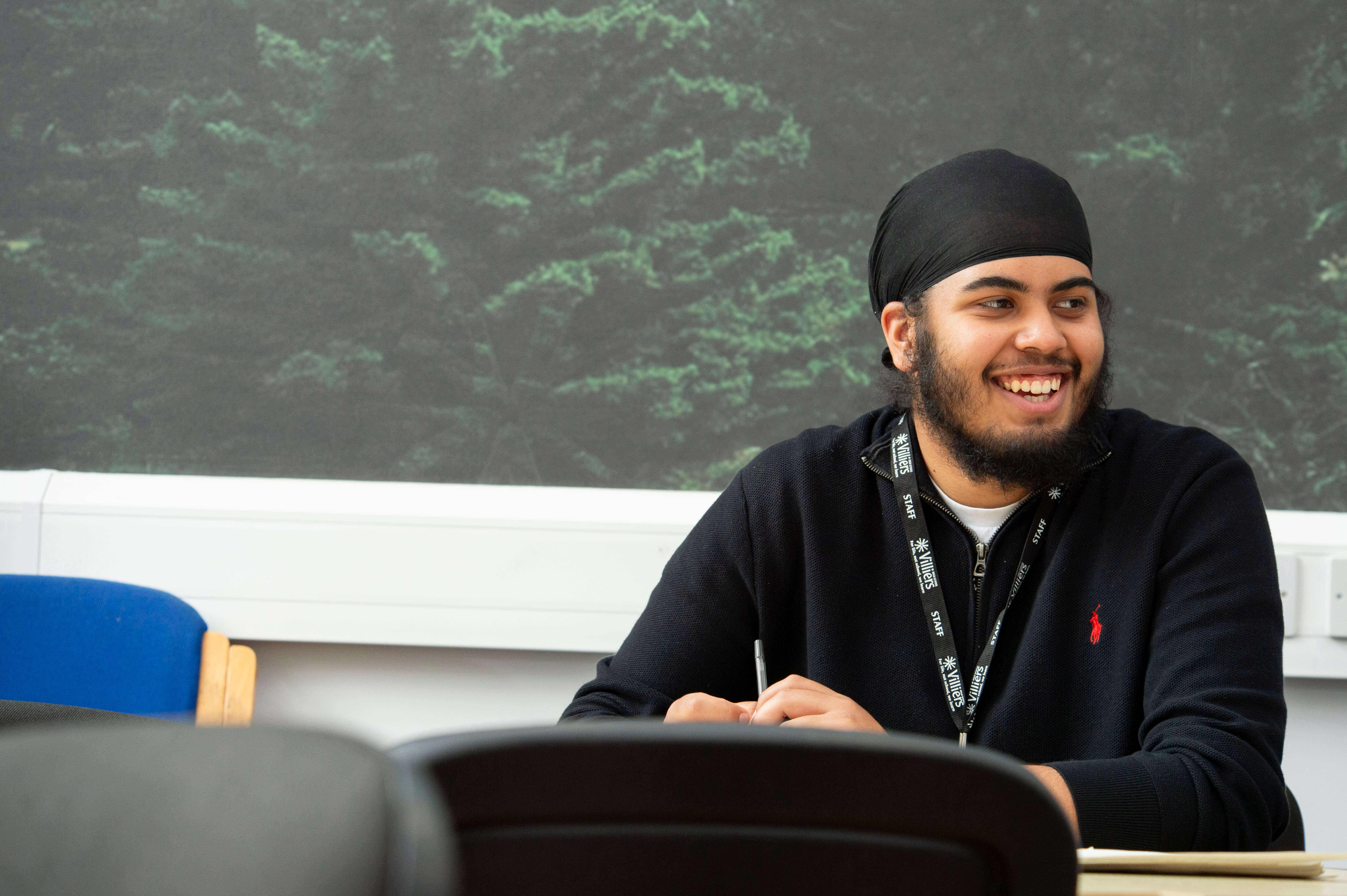 Teacher smiling in staffroom 