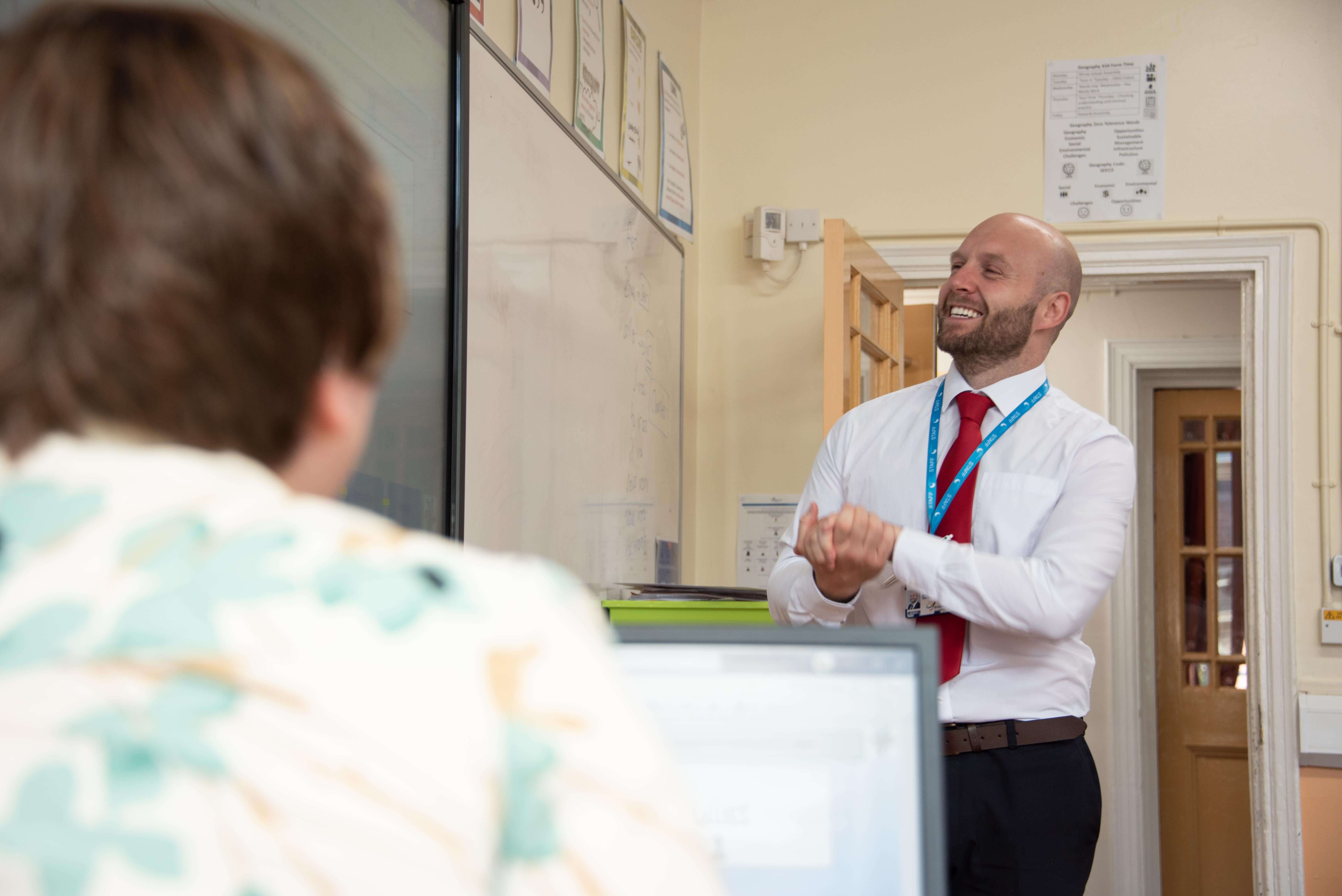 Two teachers talking in a classroom
