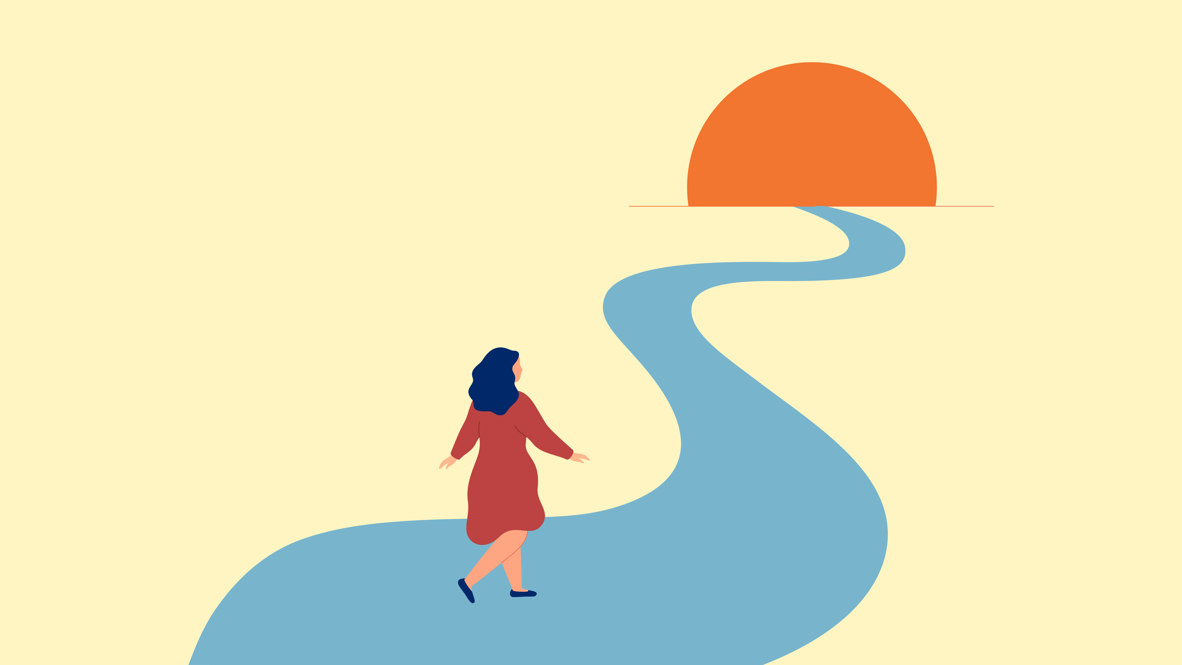 A woman walking into the sunset