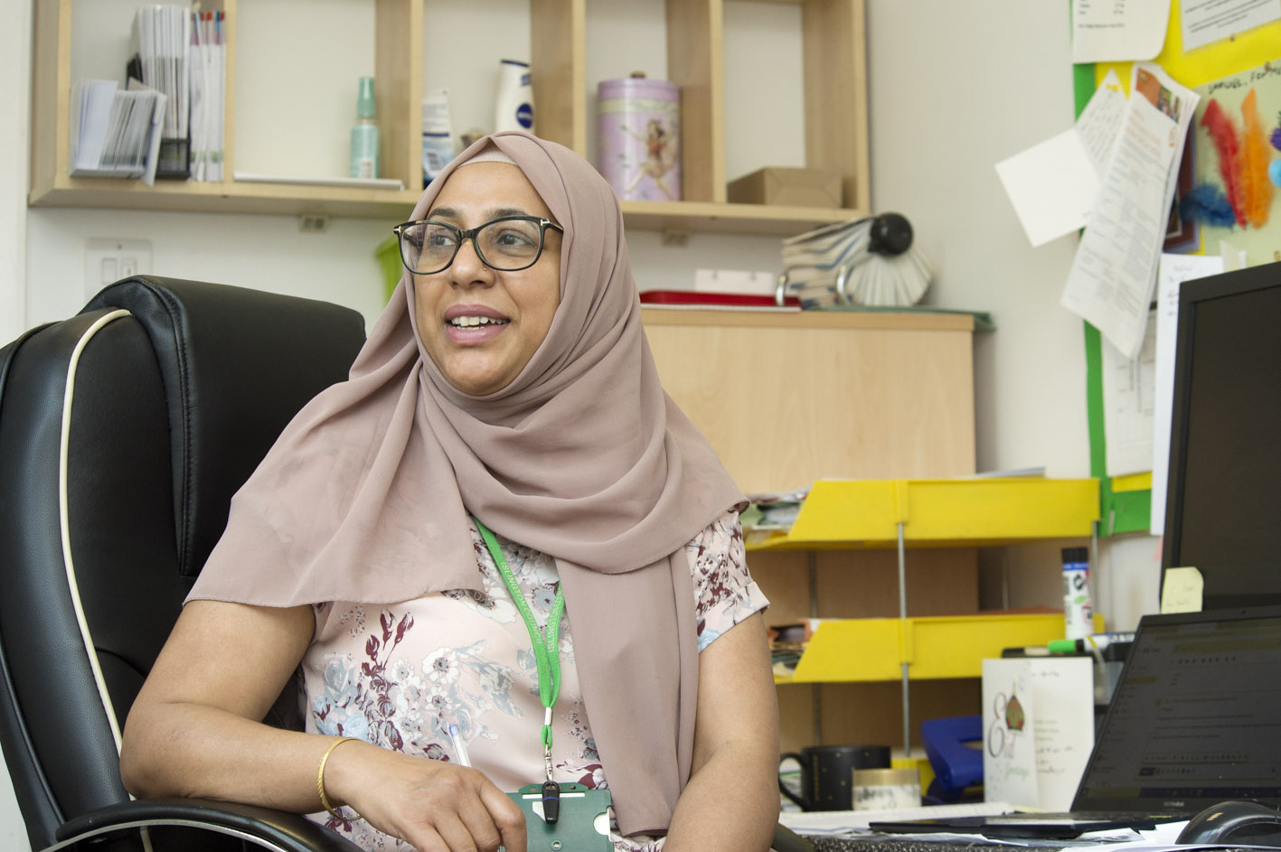 A woman sitting in a school office