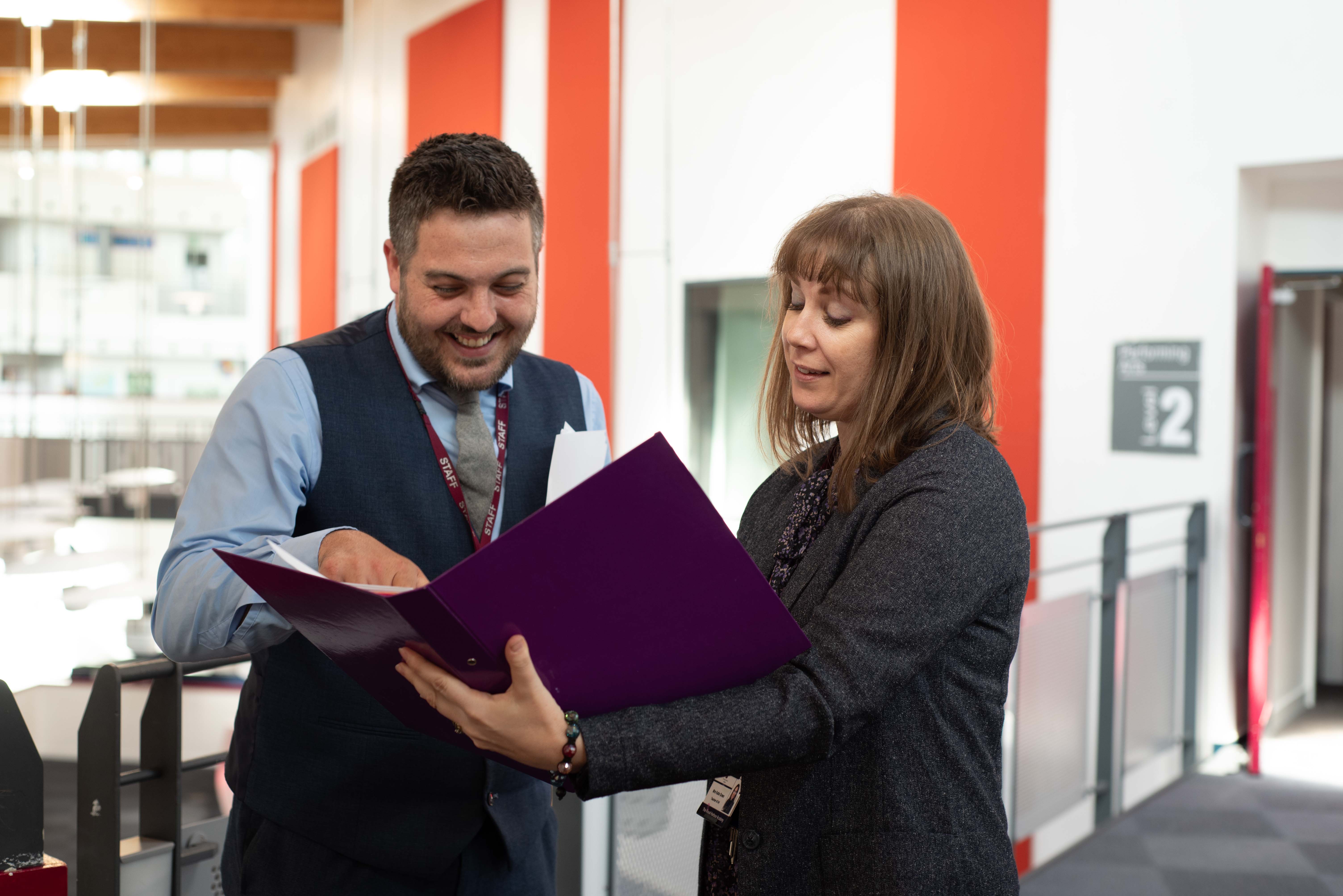 Two teachers looking at a folder